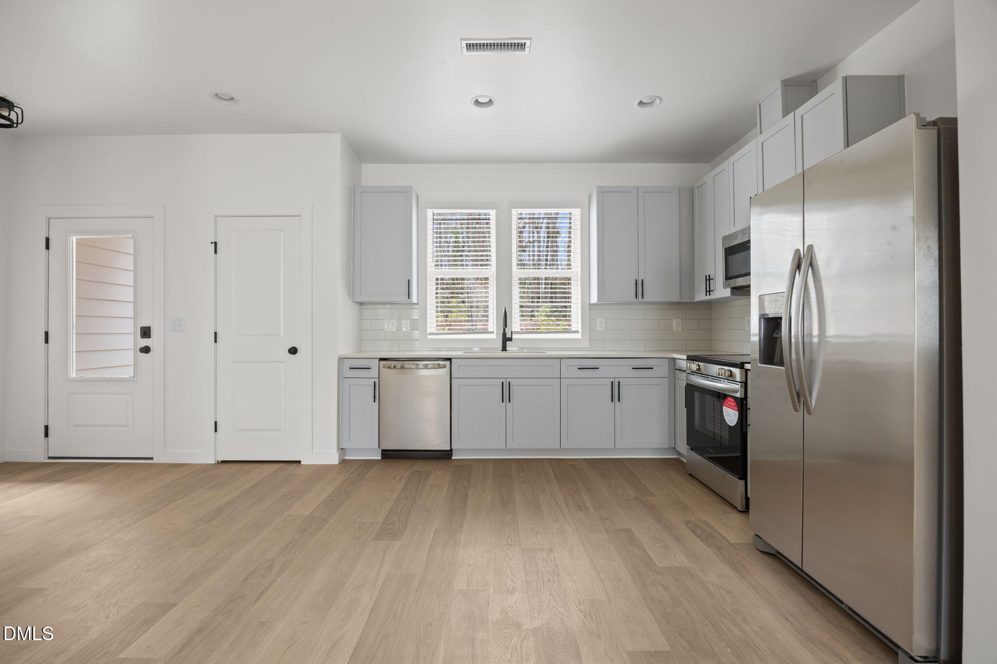 2811 Wilcox Place, Unit 101 Raleigh, NC 27607 - Photo 21 of 29 a kitchen with a refrigerator a sink and a stove top oven