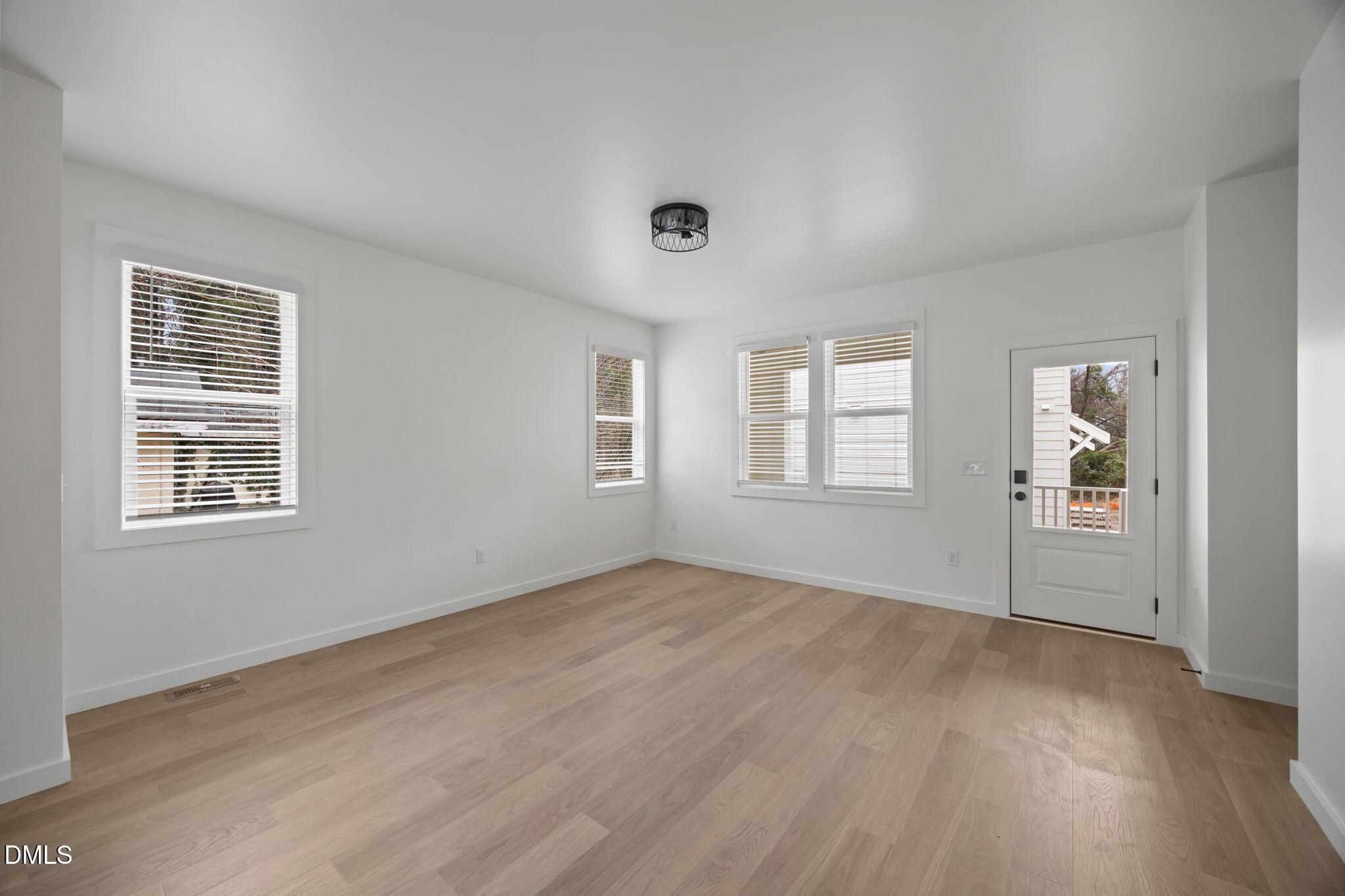 2811 Wilcox Place, Unit 101 Raleigh, NC 27607 - Photo 25 of 29 an empty room with wooden floor and windows