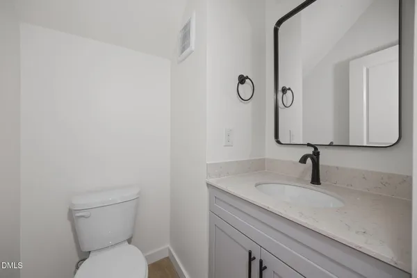 a close view of a sink and dishwasher with a window