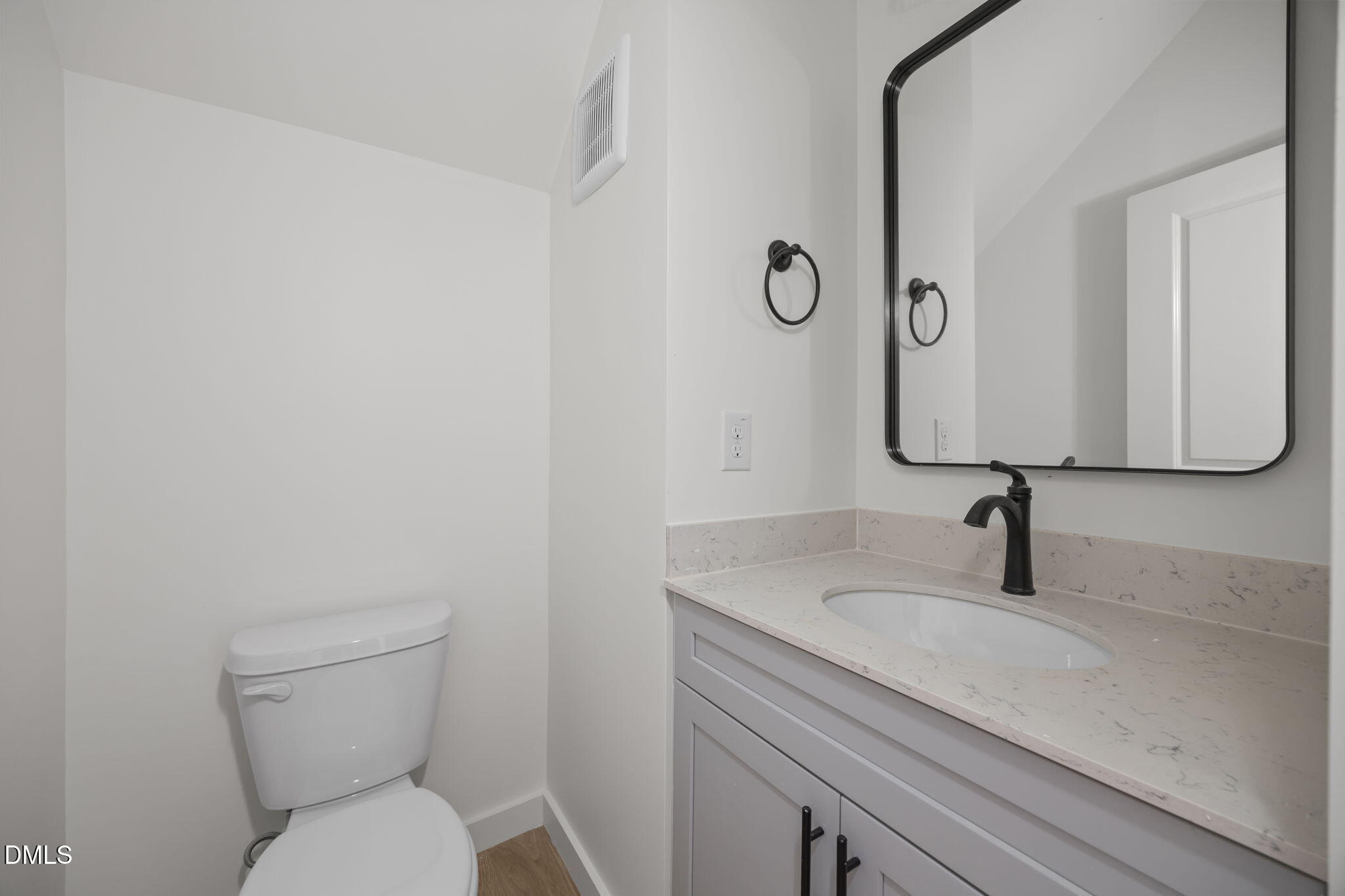 2811 Wilcox Place, Unit 101 Raleigh, NC 27607 - Photo 26 of 29 a bathroom with a toilet sink and mirror