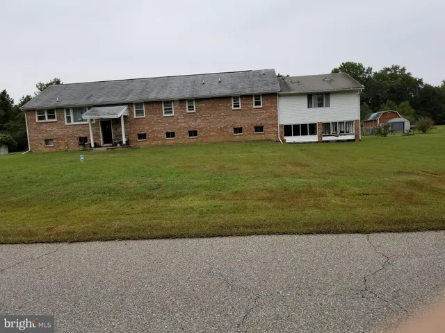 a front view of a house with a garden and yard