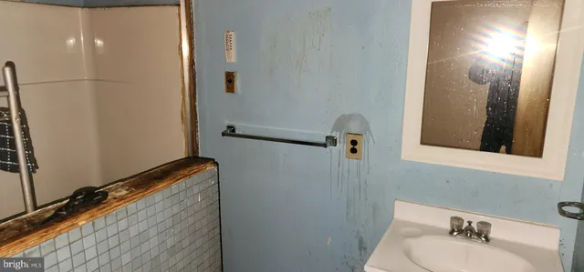 a bathroom with a sink and mirror