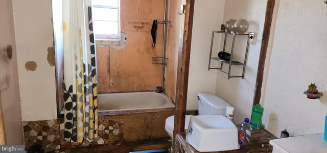 a bathroom with a tub and shower
