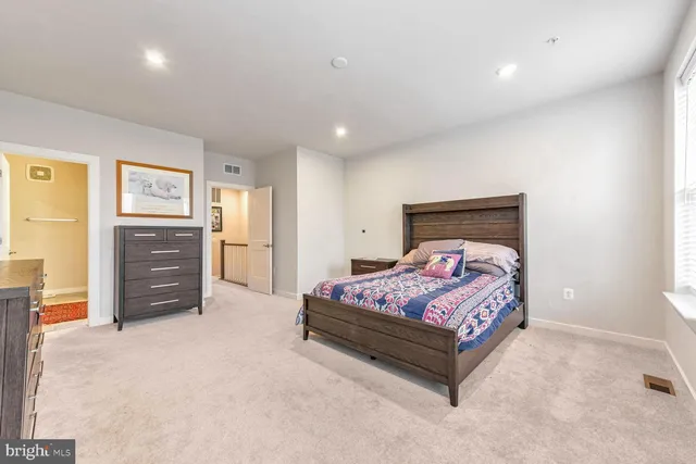 a spacious bedroom with a bed and furniture