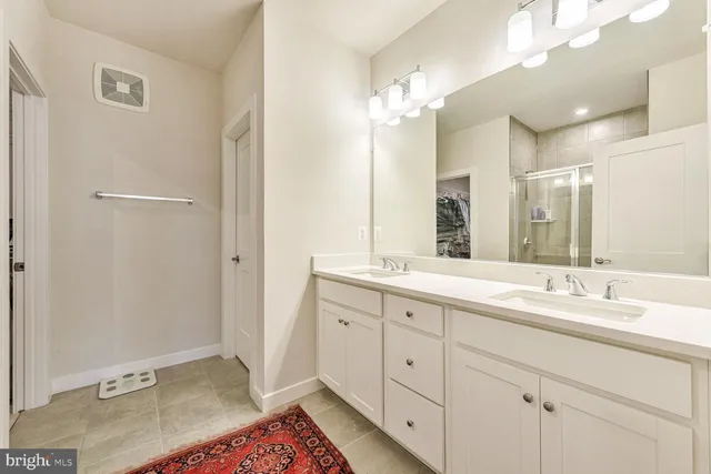 a spacious bathroom with a double vanity sink mirror and