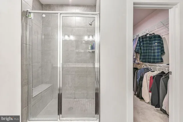 a bathroom with a shower and a mirror