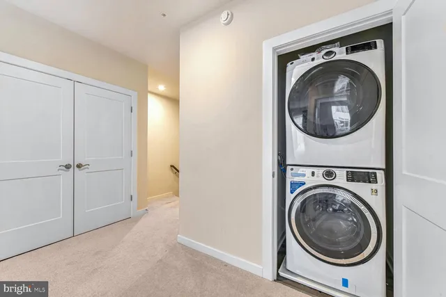 a view of a hallway with washer and dryer