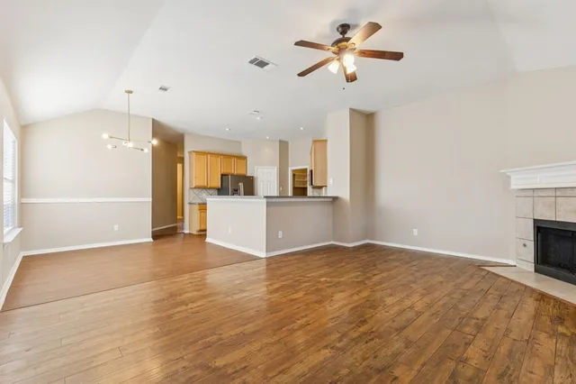 a view of a kitchen with a sink a kitchen a refrigerator and a chandelier
