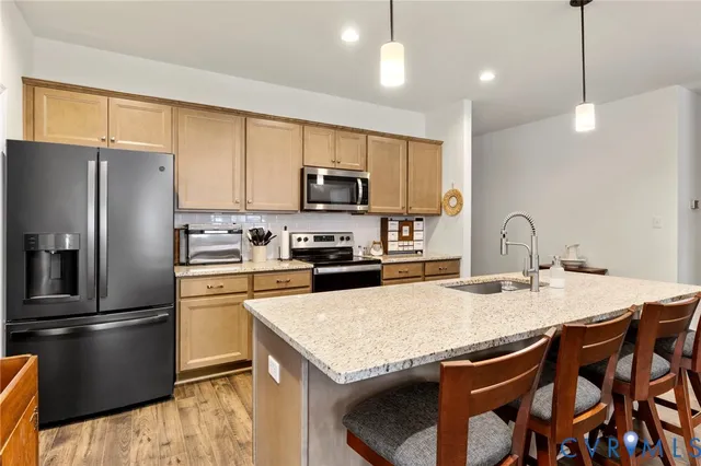 a kitchen with a stove a refrigerator and a sink