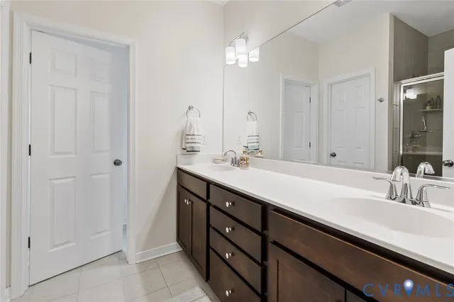 a bathroom with a double vanity sink a and a mirror