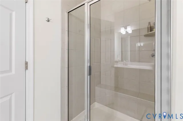 a bathroom with a glass shower door
