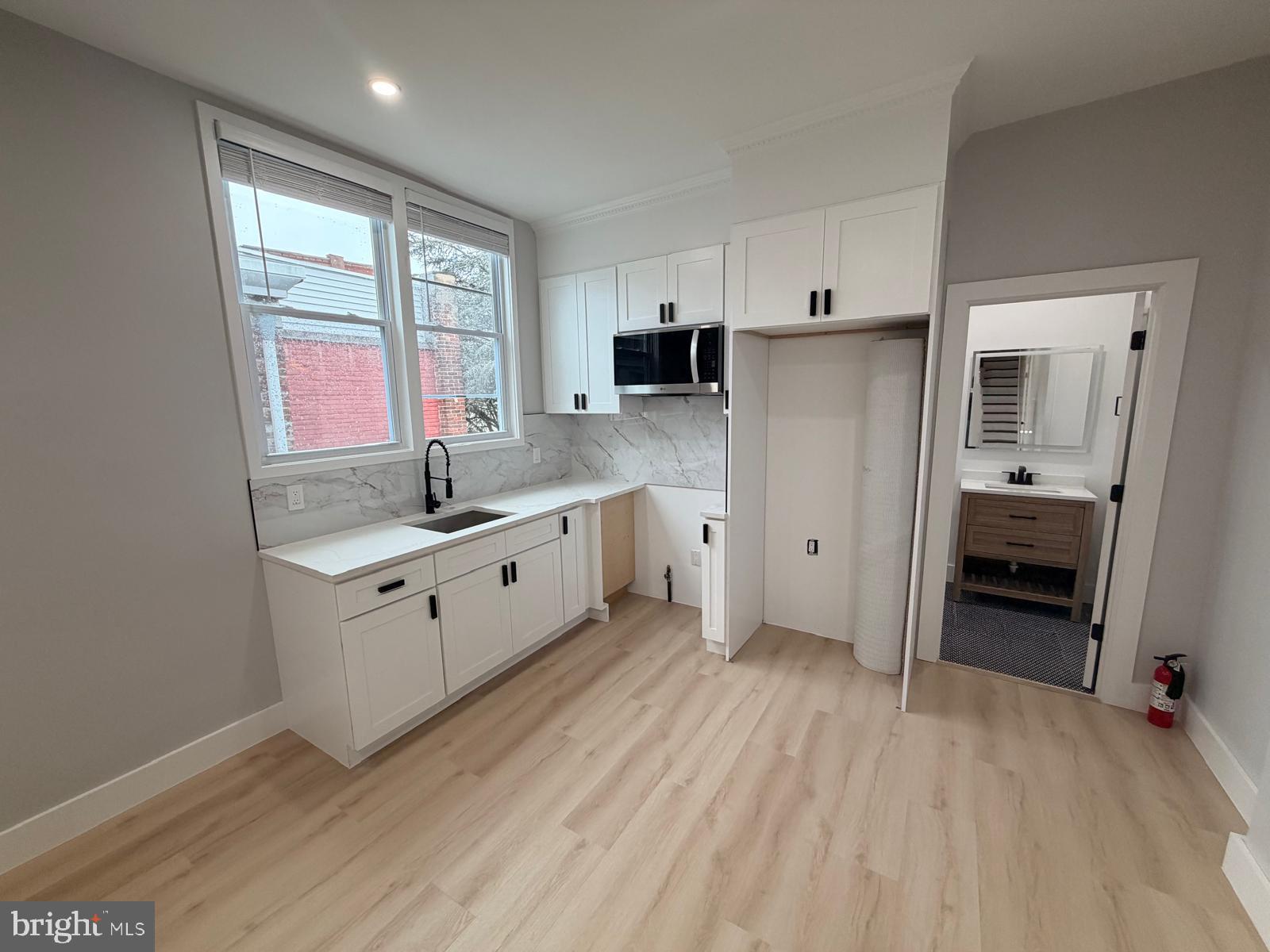 230 North 9th Street Reading, PA 19601 - Photo 2 of 20 a kitchen with a refrigerator a sink and dishwasher with wooden floor