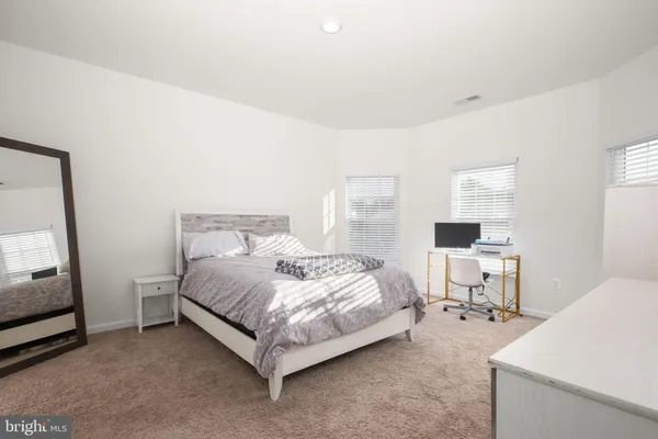 a bed room with a bed and a chair