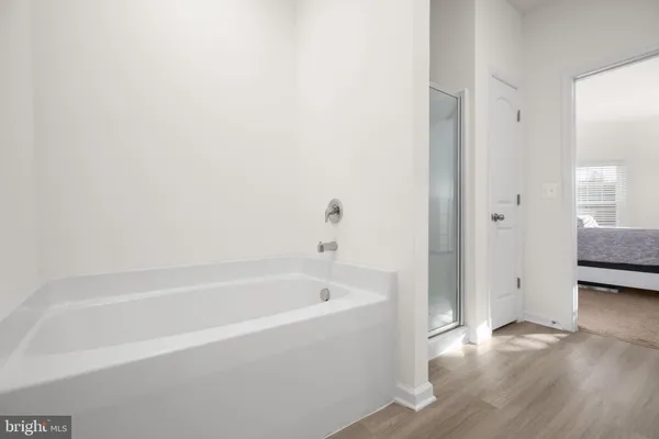 a white bath tub sitting next to a white sink