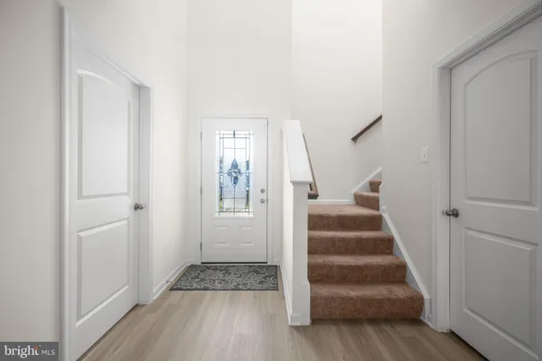 a view of entryway with wooden floor and stairs