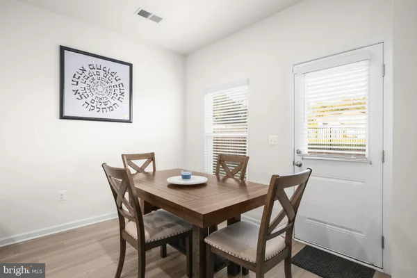 a view of a dining room with furniture and window