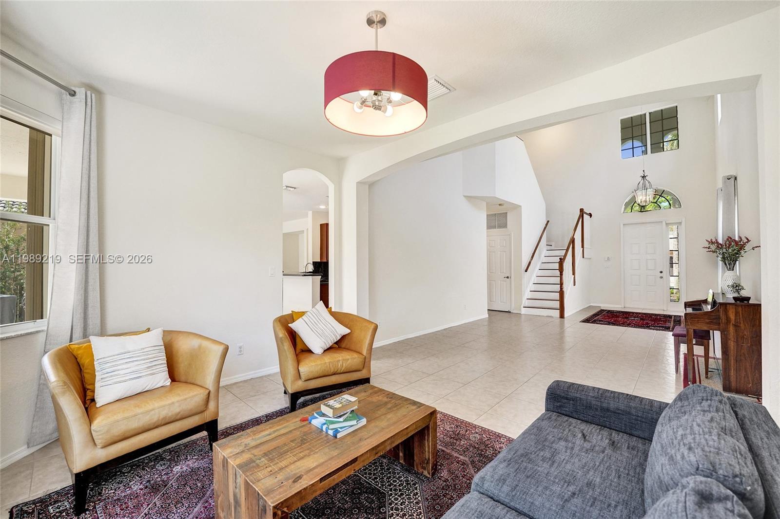 3936 Cascade Terrace Weston, FL 33332 - Photo 11 of 90 a living room with furniture and a chandelier