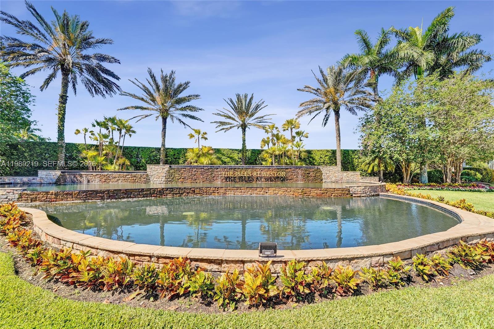 3936 Cascade Terrace Weston, FL 33332 - Photo 2 of 90 a view of a swimming pool with a garden