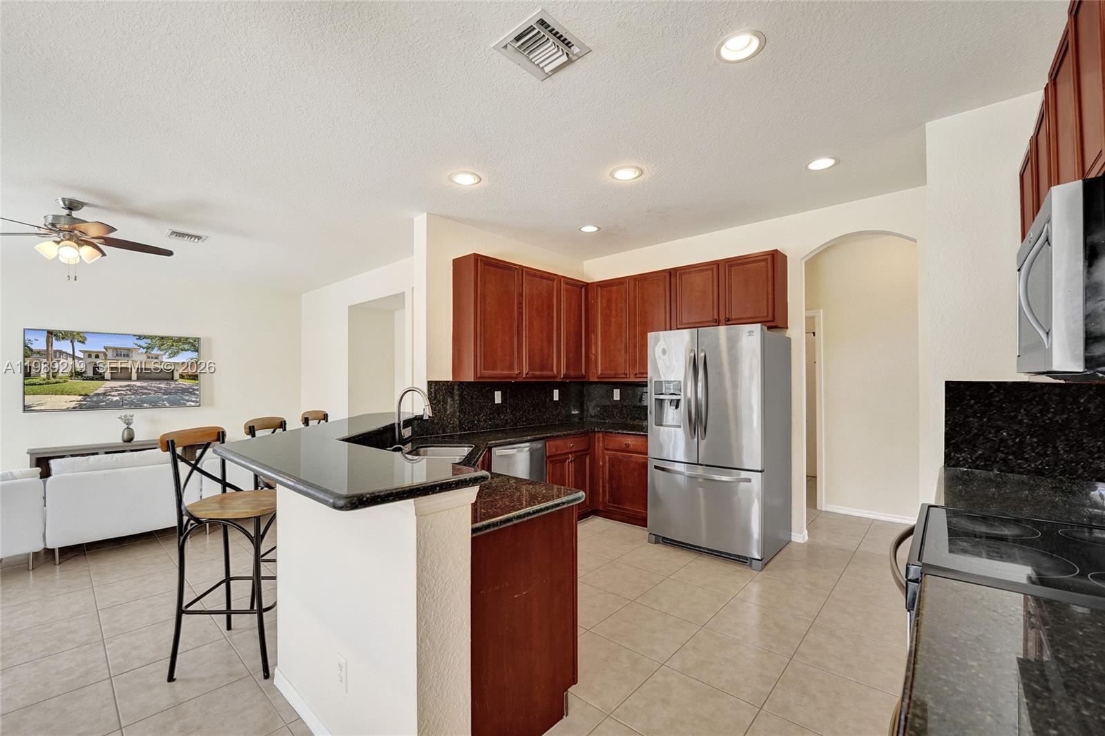 3936 Cascade Terrace Weston, FL 33332 - Photo 24 of 90 a kitchen with stainless steel appliances granite countertop a refrigerator stove and sink
