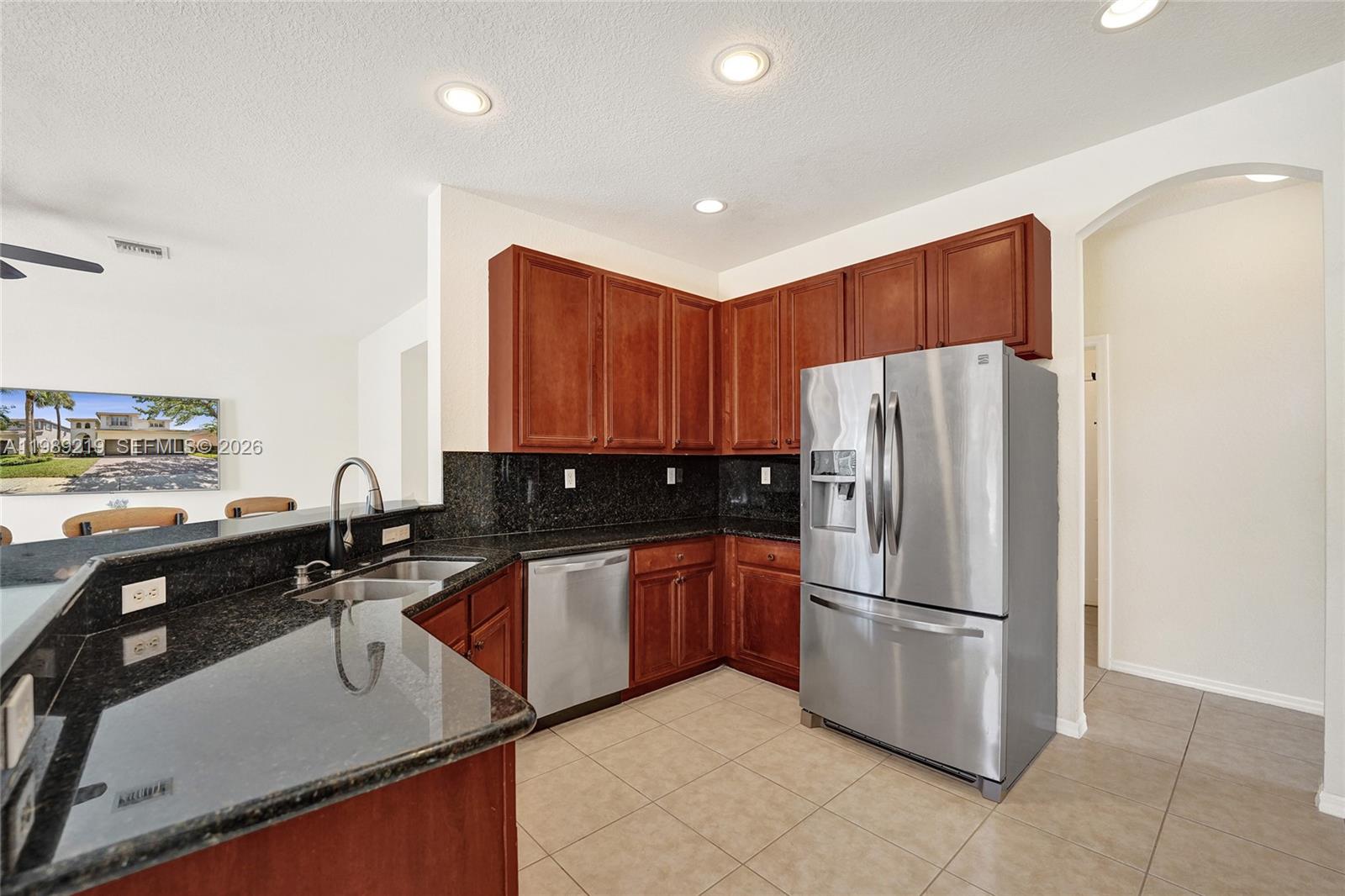 3936 Cascade Terrace Weston, FL 33332 - Photo 28 of 90 a kitchen with stainless steel appliances granite countertop a refrigerator a sink a stove and a microwave