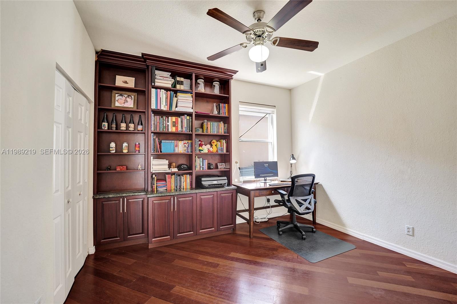 3936 Cascade Terrace Weston, FL 33332 - Photo 32 of 90 a view of a workspace with furniture and a bookshelf