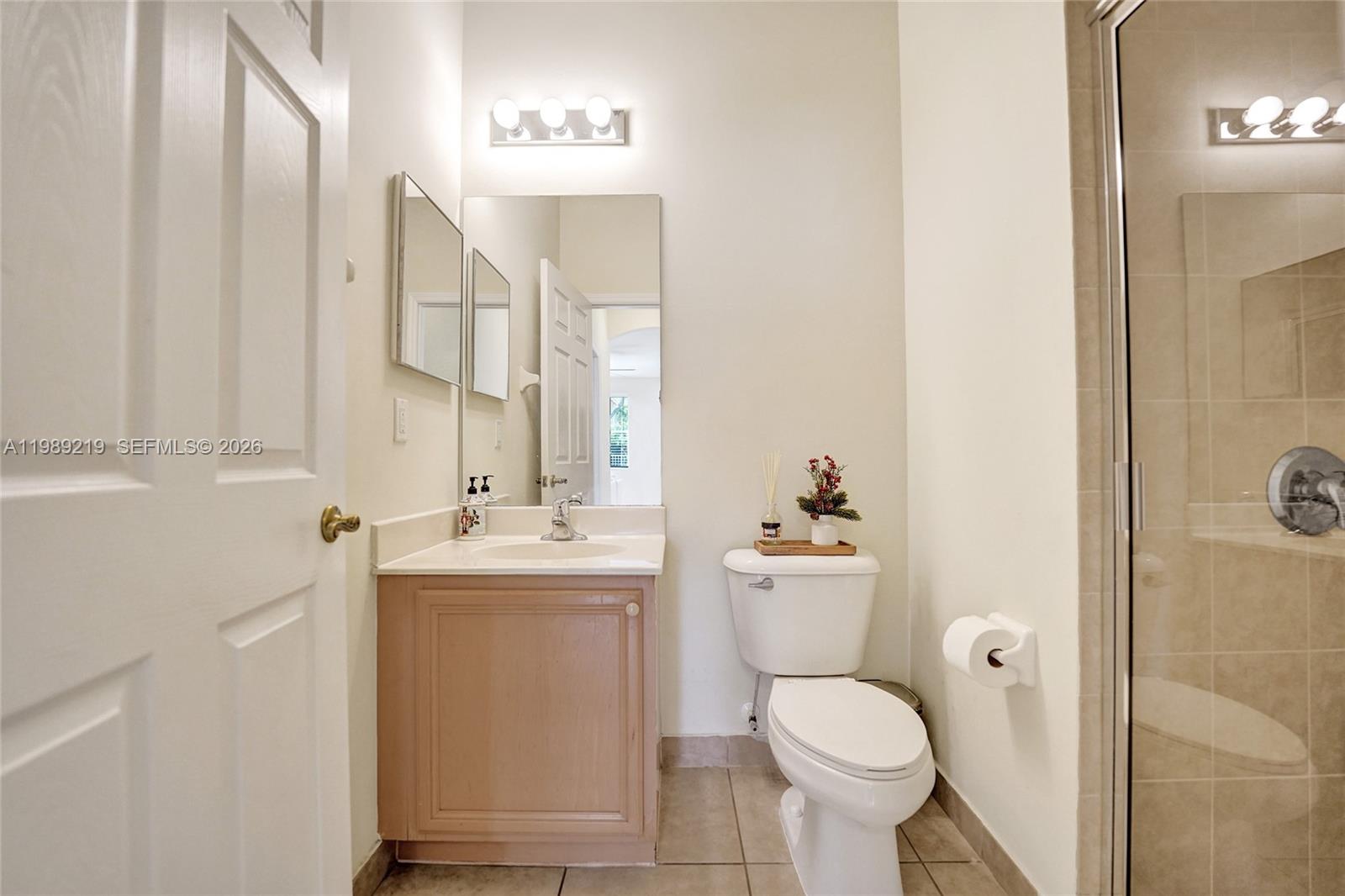 3936 Cascade Terrace Weston, FL 33332 - Photo 33 of 90 a bathroom with a toilet sink and mirror