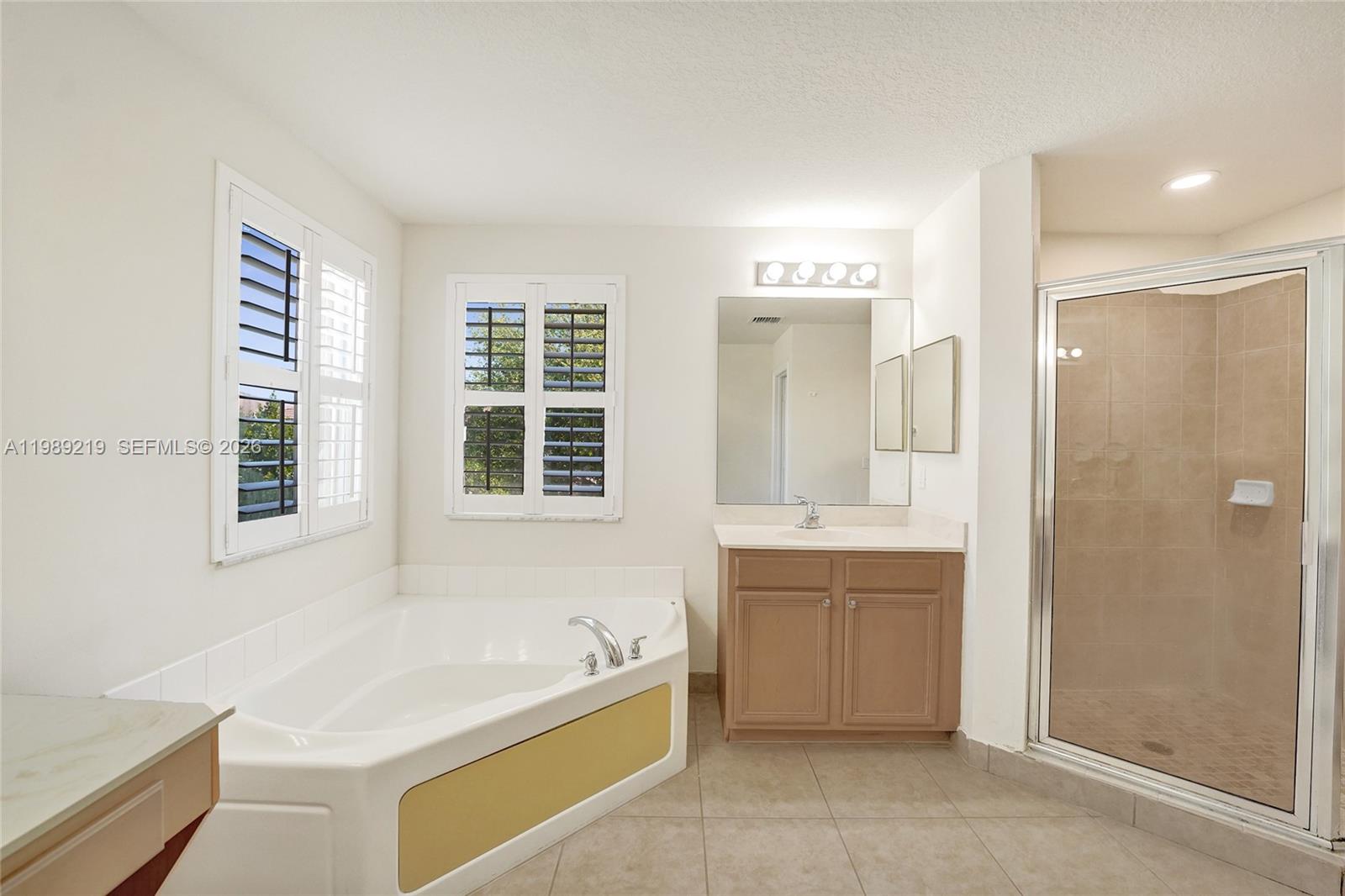 3936 Cascade Terrace Weston, FL 33332 - Photo 48 of 90 a spacious bathroom with a tub sink shower and mirror