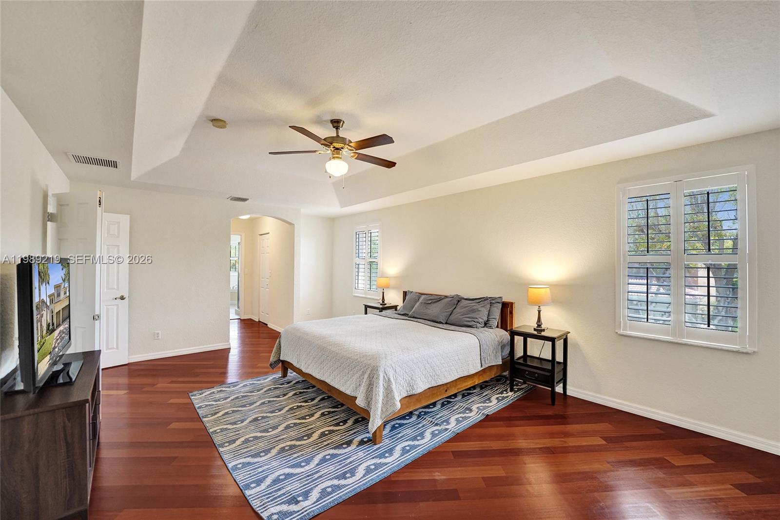3936 Cascade Terrace Weston, FL 33332 - Photo 49 of 90 a bedroom with a large bed a flat tv screen and a dresser