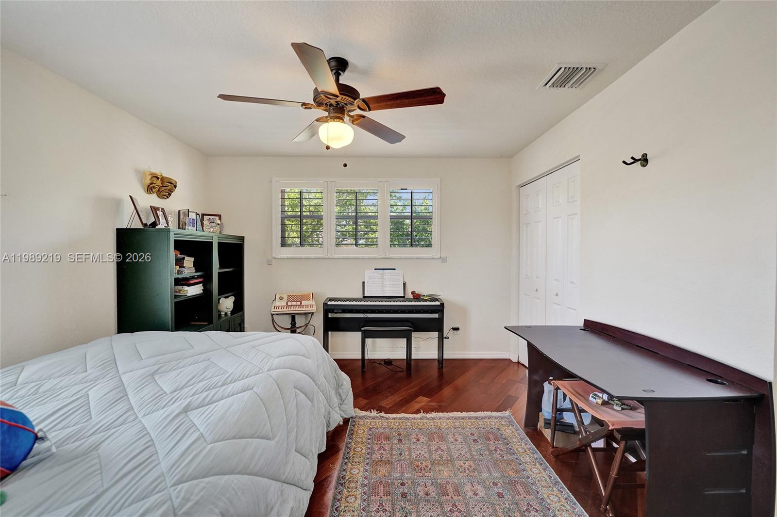 3936 Cascade Terrace Weston, FL 33332 - Photo 59 of 90 a bedroom with a bed and a dresser with wooden floor