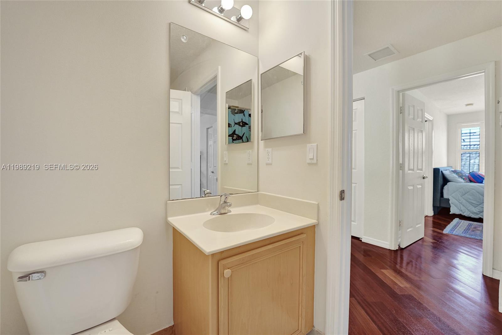 3936 Cascade Terrace Weston, FL 33332 - Photo 62 of 90 a bathroom with a sink a toilet and a mirror