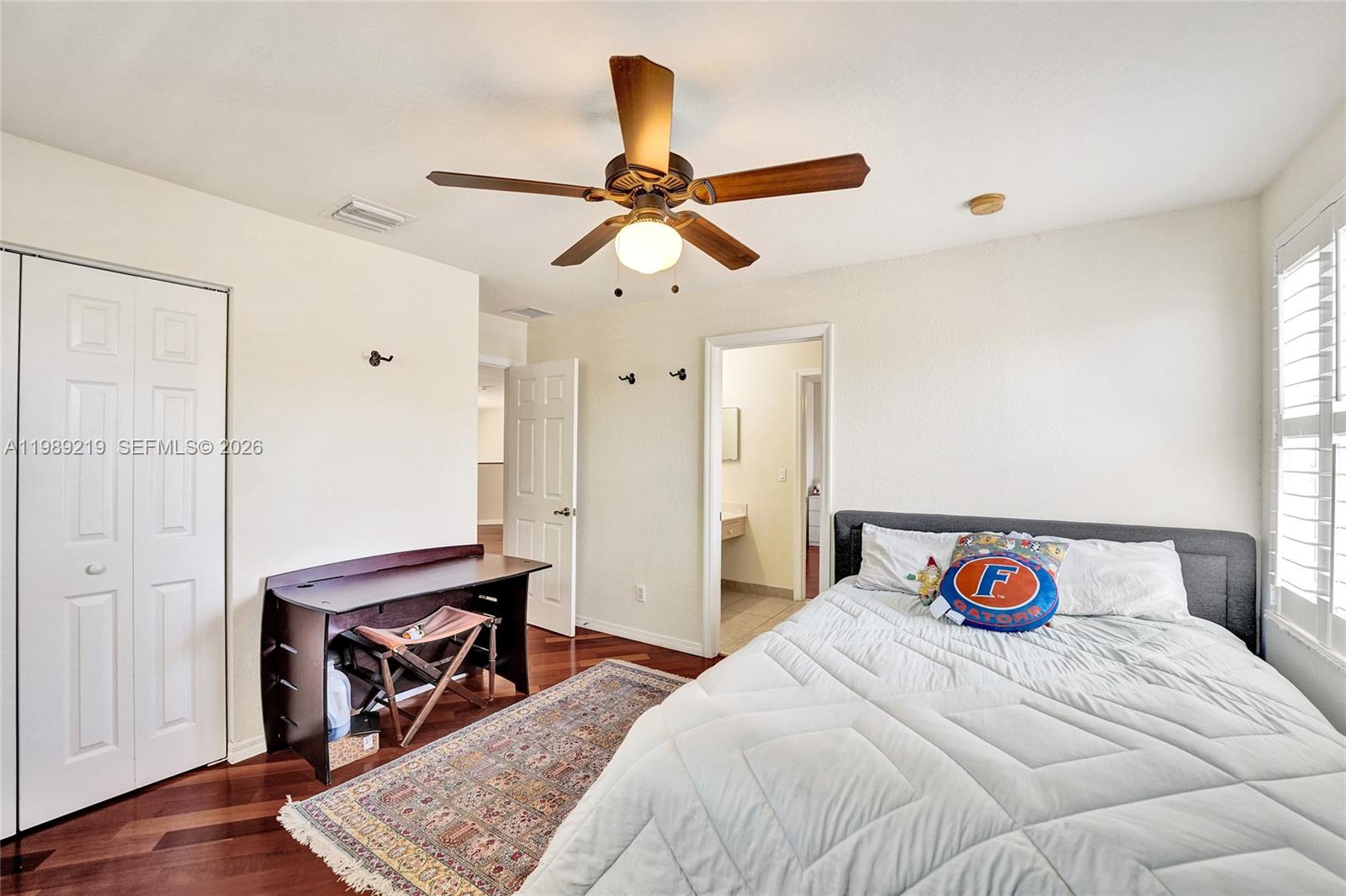3936 Cascade Terrace Weston, FL 33332 - Photo 63 of 90 a bedroom with a bed and wooden floor