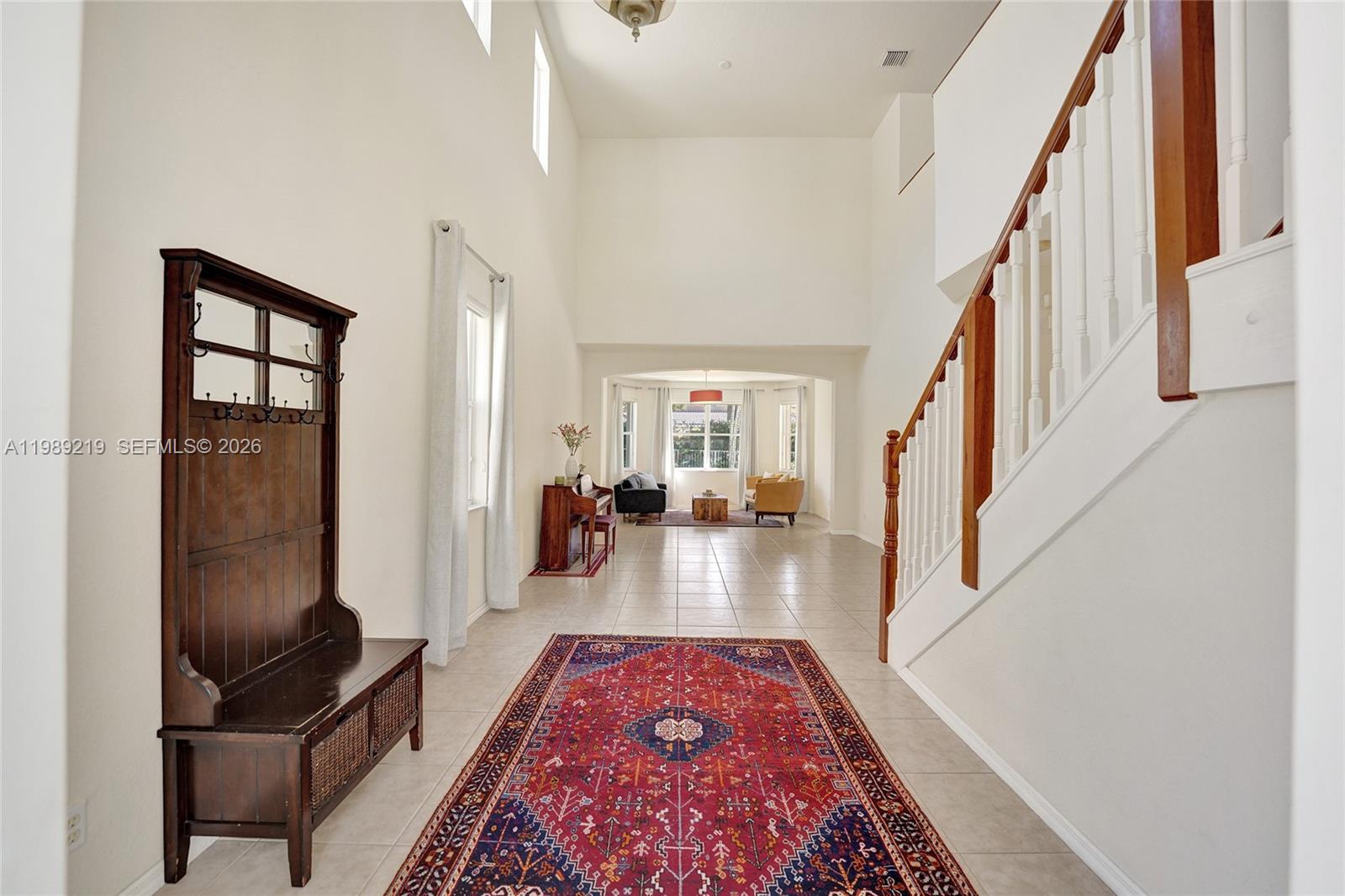 3936 Cascade Terrace Weston, FL 33332 - Photo 7 of 90 a view of a hallway to a livingroom with wooden floor and furniture