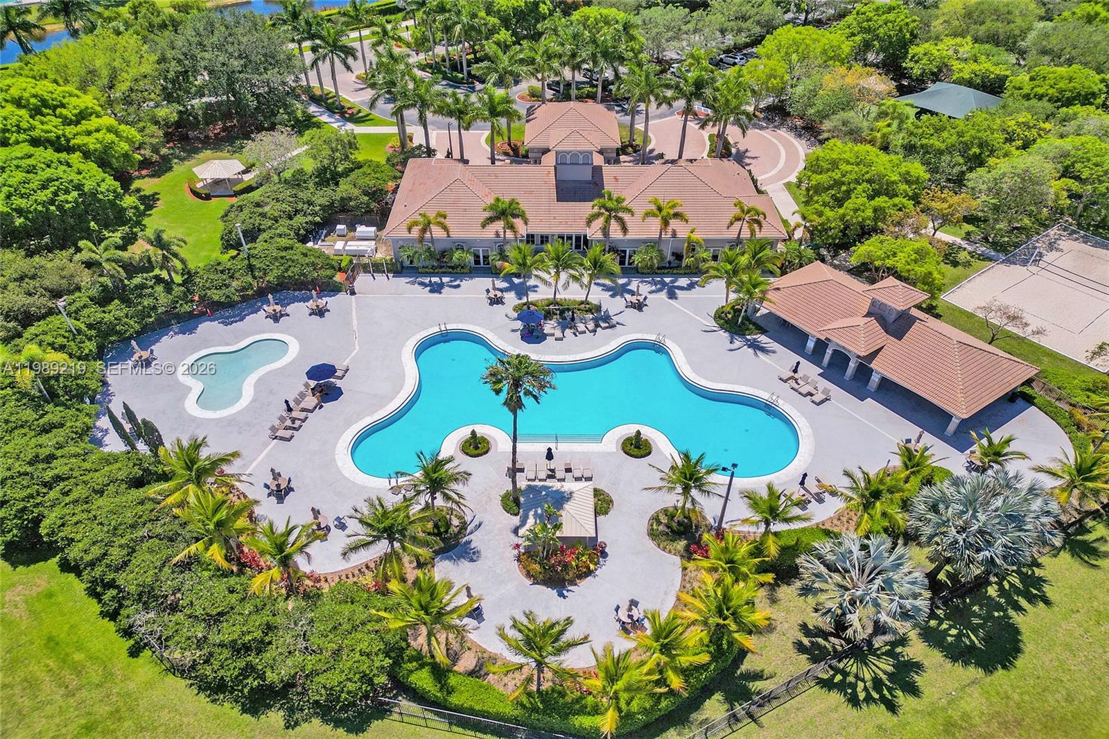 3936 Cascade Terrace Weston, FL 33332 - Photo 74 of 90 an aerial view of a swimming pool patio chairs and fire pit