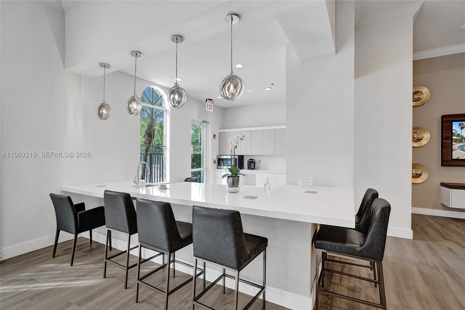 3936 Cascade Terrace Weston, FL 33332 - Photo 85 of 90 a view of a dining room with furniture a chandelier and wooden floor