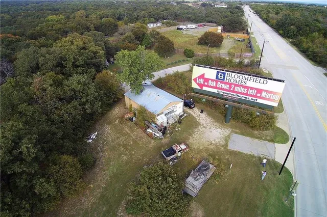 an aerial view of a house with a yard