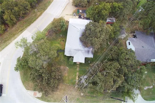an aerial view of a house with a yard and trees