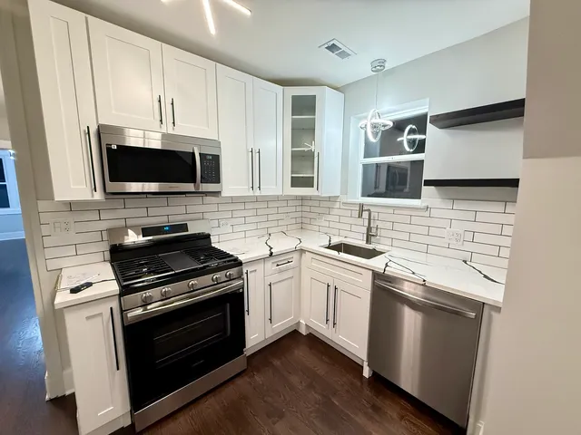 a kitchen with a stove and a microwave