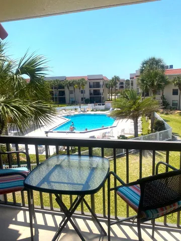 a view of a chairs and table in patio