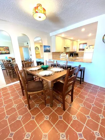 a dining room with furniture and wooden floor
