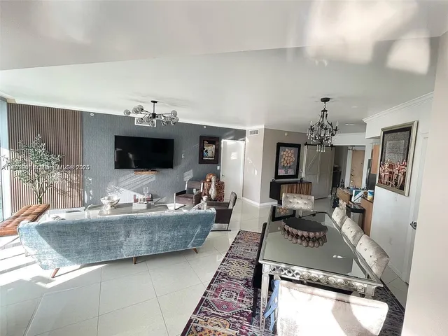 a living room with furniture and a chandelier