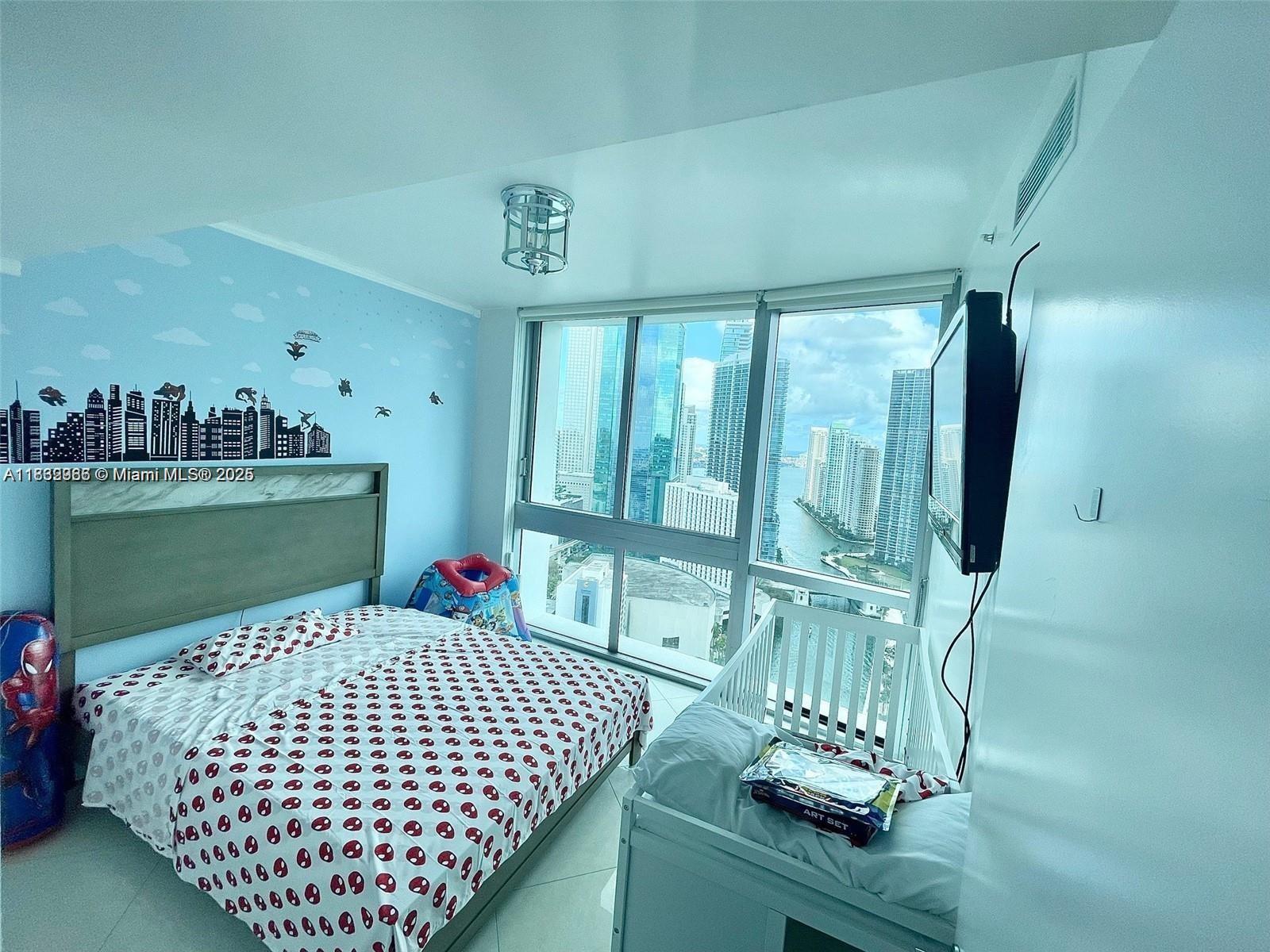 350 South Miami Avenue, Unit 3602 Miami, FL 33130 - Photo 2 of 18 a bedroom with a bed and window