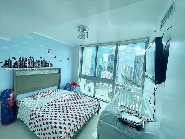 a bedroom with a bed and flat screen tv