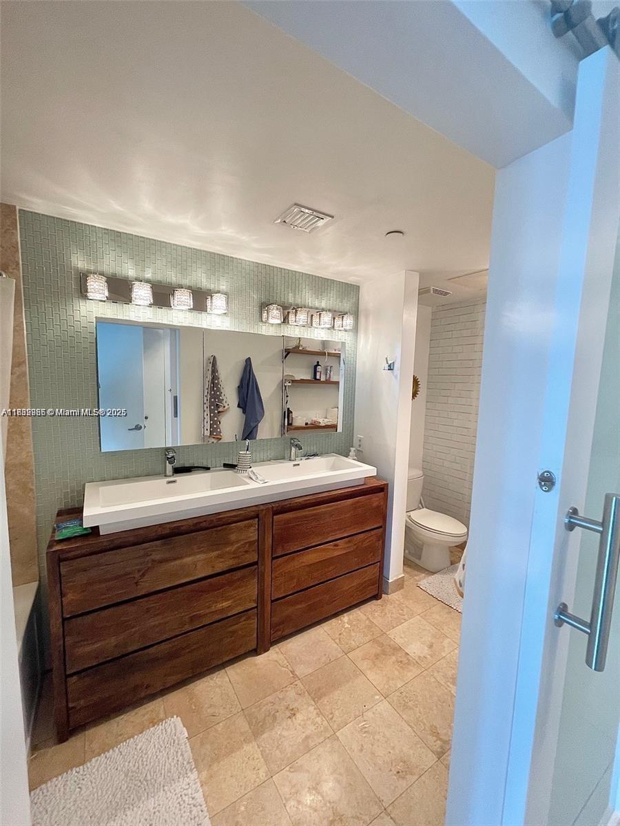 350 South Miami Avenue, Unit 3602 Miami, FL 33130 - Photo 4 of 18 a bathroom with a tub sink and mirror