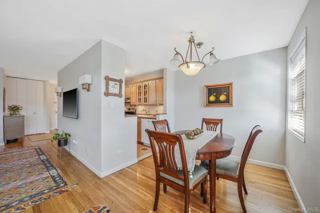 a view of a dining room with furniture wooden floor and a chandelier