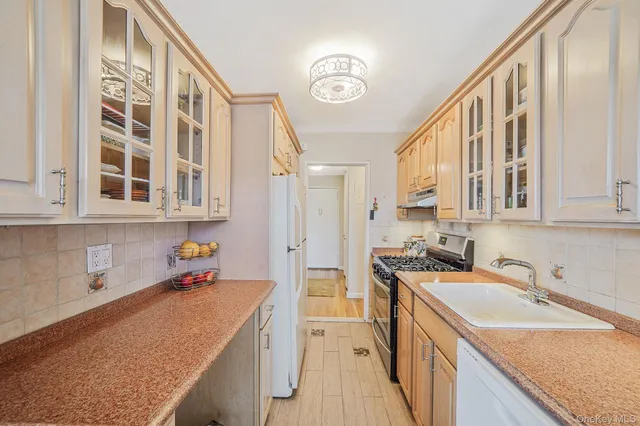 a view of a kitchen with a sink and cabinets