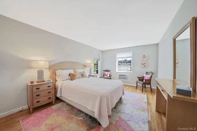 a bedroom with a bed and dresser with mirror