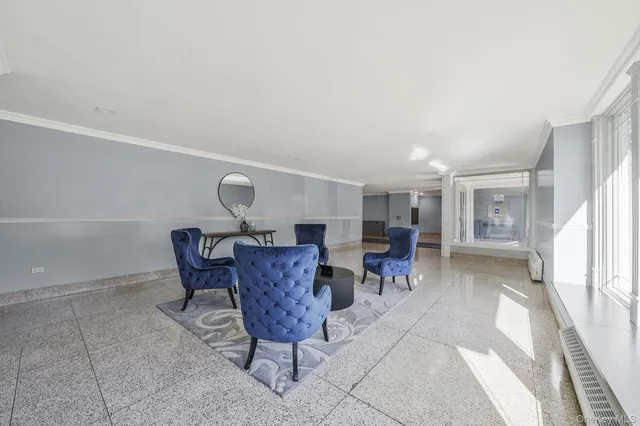 a living room with furniture a window and kitchen view