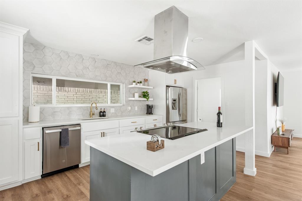 4252 McComas Road Haltom City, TX 76117 - Photo 13 of 35 a kitchen with stainless steel appliances a sink and stove
