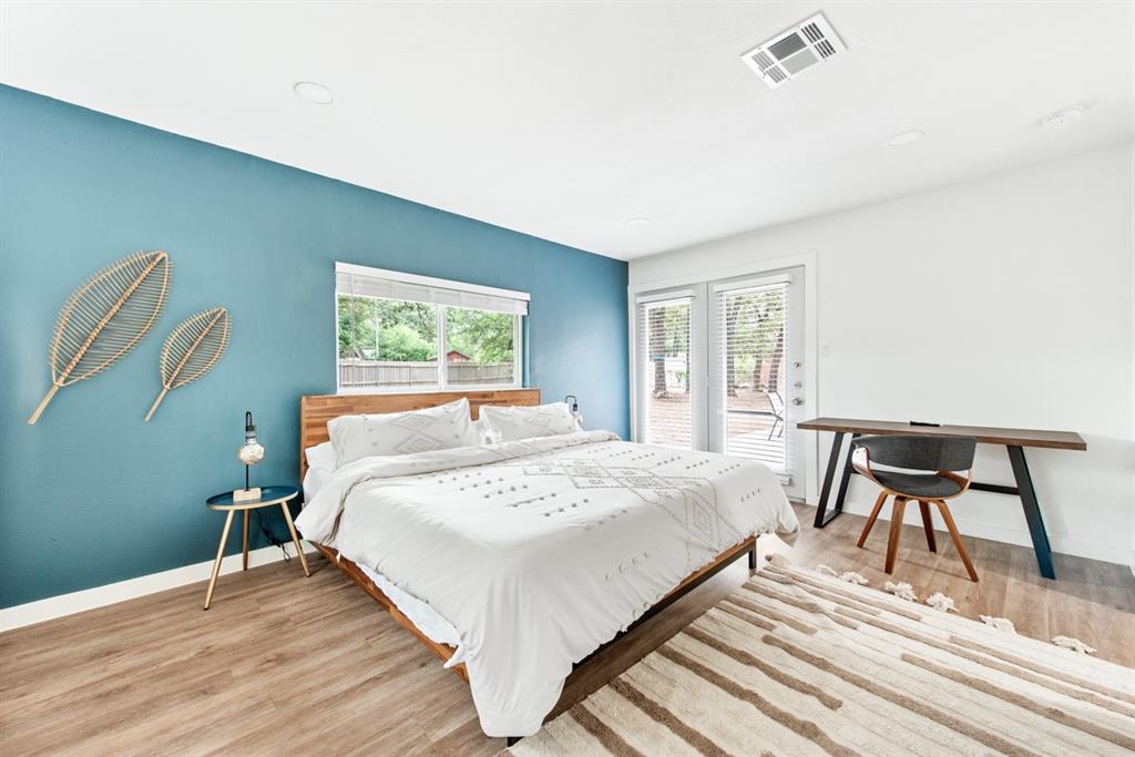 4252 McComas Road Haltom City, TX 76117 - Photo 18 of 35 a large bed sitting in a bedroom next to a window