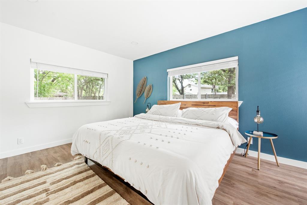 4252 McComas Road Haltom City, TX 76117 - Photo 19 of 35 a large bed sitting in a bedroom next to a window